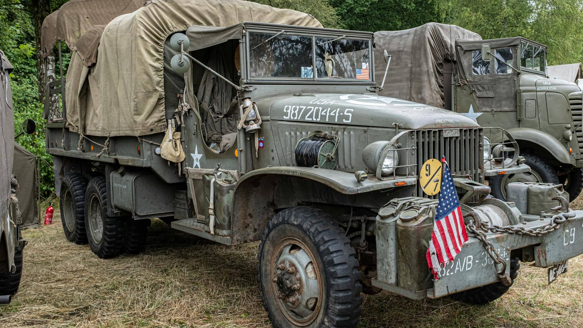 photo of military vehicle parked on grass